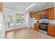 Bright kitchen with stainless steel appliances, wood cabinets, and door to the patio at 5318 Crescentview Pkwy, Raleigh, NC 27606
