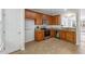 Well-lit kitchen with wood cabinets, granite countertops, and stainless steel appliances at 5318 Crescentview Pkwy, Raleigh, NC 27606