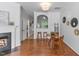 Open living space with hardwood floors, fireplace, and breakfast nook with barstool seating at 5318 Crescentview Pkwy, Raleigh, NC 27606