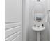 Clean powder room featuring a pedestal sink, large oval mirror, and neutral walls at 5318 Crescentview Pkwy, Raleigh, NC 27606