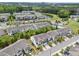 Aerial view of a residential community featuring townhomes, green spaces, and a community pool at 5518 Jessip St, Morrisville, NC 27560