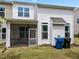 Home's backyard featuring a screened porch area, vinyl siding, and well-kept lawn at 5518 Jessip St, Morrisville, NC 27560