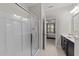Bathroom featuring glass-enclosed shower, modern vanity, and neutral color palette at 5518 Jessip St, Morrisville, NC 27560