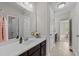 Bathroom featuring a large mirror, vanity with dark cabinets, and neutral tile floors at 5518 Jessip St, Morrisville, NC 27560