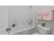 Clean bathroom featuring a shower-tub combo and neutral decor that creates a relaxing atmosphere at 5518 Jessip St, Morrisville, NC 27560