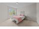 Bright bedroom with a large window, offering natural light and a peaceful view at 5518 Jessip St, Morrisville, NC 27560