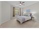 Comfortable bedroom with a ceiling fan and natural light from the large window at 5518 Jessip St, Morrisville, NC 27560