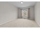 Bedroom with neutral walls, carpet flooring, and a window offering natural light and neighborhood views at 5518 Jessip St, Morrisville, NC 27560