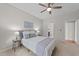 Comfortable bedroom with a ceiling fan and natural light from the large window at 5518 Jessip St, Morrisville, NC 27560