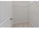 Walk-in closet with white walls, carpeted floors, and wire shelving for optimal storage at 5518 Jessip St, Morrisville, NC 27560