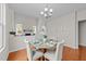 Bright dining room featuring wood floors, stylish furnishings, and elegant lighting at 5518 Jessip St, Morrisville, NC 27560