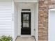 Inviting front entrance with black door, stone accents, and well-manicured landscaping at 5518 Jessip St, Morrisville, NC 27560