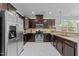 Well-equipped kitchen featuring stainless steel appliances, granite countertops, and dark wood cabinetry at 5518 Jessip St, Morrisville, NC 27560