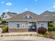 View of a pool house featuring stone accents, neutral siding, and a gated entrance to the pool area at 5518 Jessip St, Morrisville, NC 27560