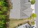 Overhead view showcases the roof of a well-maintained single-Gathering home with a lawn and mature trees at 5518 Jessip St, Morrisville, NC 27560