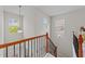 A well-lit staircase with decorative iron railings leads to the upper level of the home at 5518 Jessip St, Morrisville, NC 27560