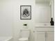 Small bathroom featuring a toilet, vanity with a sink, and modern decor at 613 Cassa Clubhouse Way, Knightdale, NC 27545