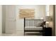 Cozy bedroom with a black bed frame, bedside table, and modern wall art at 613 Cassa Clubhouse Way, Knightdale, NC 27545