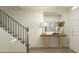 Bright entryway with staircase, wooden console table, mirror, and modern decor at 613 Cassa Clubhouse Way, Knightdale, NC 27545