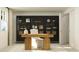 Modern home office with stylish wooden desk, sleek black cabinet, and neutral color palette at 613 Cassa Clubhouse Way, Knightdale, NC 27545