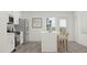 Bright kitchen features an island with seating, stainless steel appliances, and white cabinets at 613 Cassa Clubhouse Way, Knightdale, NC 27545