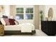 Cozy bedroom featuring decorative pillows, wall art, and natural lighting at 615 Cassa Clubhouse Way, Knightdale, NC 27545