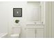 Clean bathroom includes white vanity, framed mirror, toilet, and neutral finishes at 617 Cassa Clubhouse Way, Knightdale, NC 27545