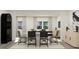 Open-concept dining area features modern furnishings, neutral color palettes, and ample natural light at 617 Cassa Clubhouse Way, Knightdale, NC 27545