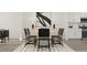 Elegant dining room featuring a white table, six chairs, modern decor, and ample lighting at 617 Cassa Clubhouse Way, Knightdale, NC 27545
