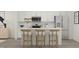 Modern kitchen featuring a kitchen island with seating, stainless steel appliances, and white cabinets at 617 Cassa Clubhouse Way, Knightdale, NC 27545