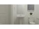 Modern powder room features a sleek pedestal sink, toilet, and artwork at 617 Cassa Clubhouse Way, Knightdale, NC 27545