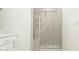 This tile shower features a glass door, a built-in seat, and modern hardware at 617 Cassa Clubhouse Way, Knightdale, NC 27545