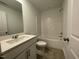 Clean bathroom featuring a white vanity, tile flooring, and a shower-tub combo with white tile at 621 Cassa Clubhouse Way, Knightdale, NC 27545