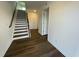 Inviting foyer with stylish hardwood flooring, a staircase with white risers, and neutral walls at 621 Cassa Clubhouse Way, Knightdale, NC 27545
