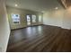 Spacious living room filled with natural light from windows and doors and featuring sleek hardwood floors at 621 Cassa Clubhouse Way, Knightdale, NC 27545