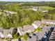 Aerial view of townhome community, showcasing parking areas, landscaped grounds, and surrounding green space at 6230 Pesta Ct, Raleigh, NC 27612