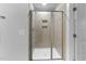 Modern bathroom with a glass enclosed shower and tiled walls at 6230 Pesta Ct, Raleigh, NC 27612