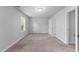 Neutral bedroom with large window, light carpet and a walk-in closet at 6230 Pesta Ct, Raleigh, NC 27612