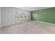 Spacious bedroom featuring plush carpet, neutral walls, and large window at 6230 Pesta Ct, Raleigh, NC 27612