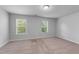 Bright bedroom with large windows and neutral carpeting at 6230 Pesta Ct, Raleigh, NC 27612