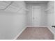 Walk-in closet with wire shelving, neutral carpet and freshly painted walls, offering ample storage space at 6230 Pesta Ct, Raleigh, NC 27612