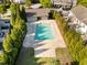 Aerial of fenced in community pool surrounded by mature trees and concrete patio at 6230 Pesta Ct, Raleigh, NC 27612