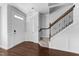 Bright entryway featuring hardwood floors and staircase with elegant railing, creating a welcoming ambiance at 6230 Pesta Ct, Raleigh, NC 27612