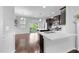 Bright kitchen featuring stainless steel appliances, dark cabinetry, granite countertops, and sliding door access to outdoor patio at 6230 Pesta Ct, Raleigh, NC 27612
