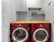 Laundry room with front loading washer and dryer and wood countertop at 6230 Pesta Ct, Raleigh, NC 27612