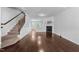 Open-concept living area with hardwood floors, fireplace and staircase, ideal for entertaining guests at 6230 Pesta Ct, Raleigh, NC 27612