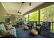Relaxing screened-in porch with comfortable seating, a ceiling fan, and serene backyard views at 658 Bennett Mountain Trce, Chapel Hill, NC 27516