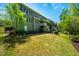 A shot of the backyard including the patio, deck, lush grass, and manicured landscaping at 658 Bennett Mountain Trce, Chapel Hill, NC 27516