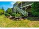 Large backyard with green grass, a patio area, a deck, and mature landscaping at 658 Bennett Mountain Trce, Chapel Hill, NC 27516