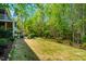 Secluded backyard with well-maintained lawn, mature trees and patio area at 658 Bennett Mountain Trce, Chapel Hill, NC 27516